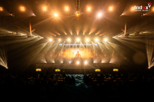 Corporate convention event production featuring large stage lighting design and visual presentation