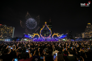 Drone show above an urban event stage with a large audience